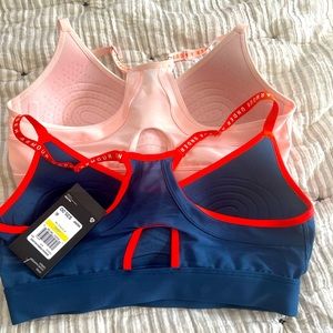 Under armor sports bra! Never worn! I ripped the tags off the pink one.